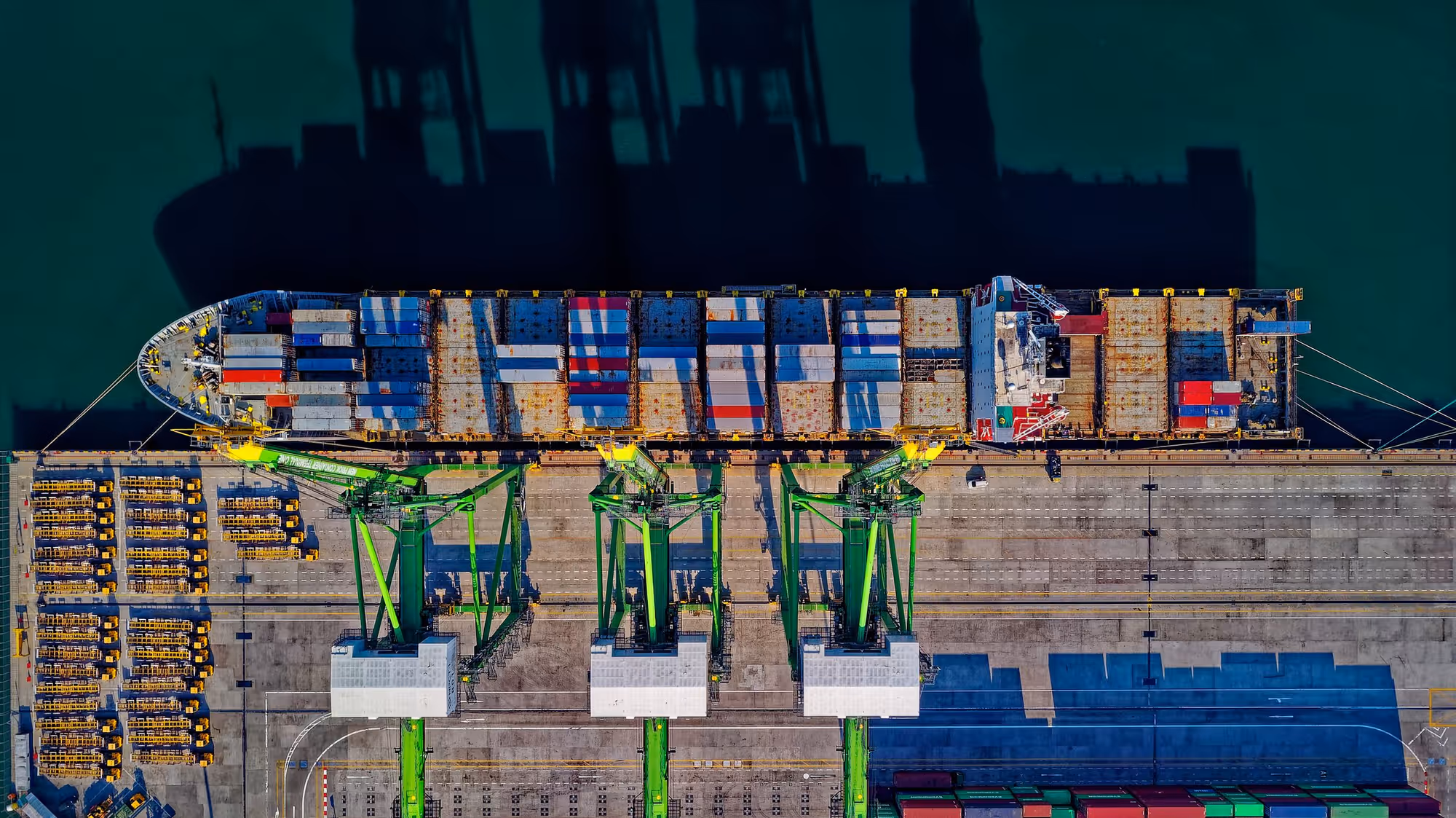 Aerial view of a container ship being loaded by gantry cranes